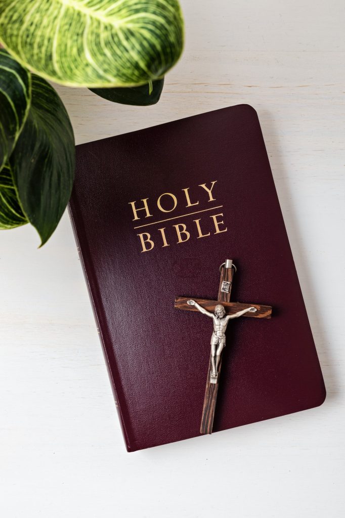 Holy Bible on white wooden table. Christian devotion, Easter celebration