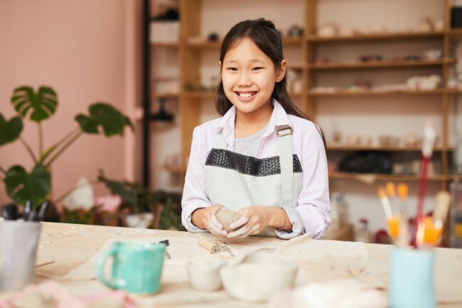 Smiling Asian Girl Enjoying Pottery Class Smiling Asian Girl Enjoying Pottery Class