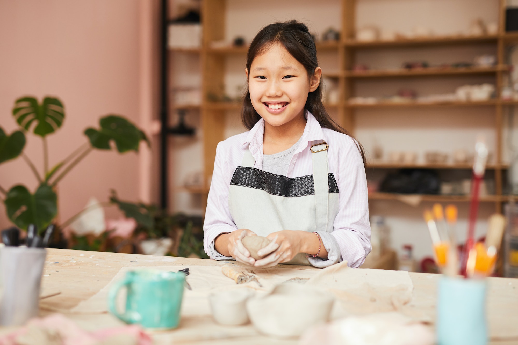 Smiling Asian Girl Enjoying Pottery Class
