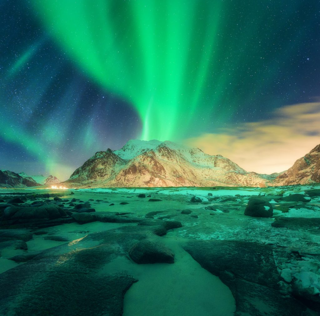 Aurora over snowy mountains. Northern lights